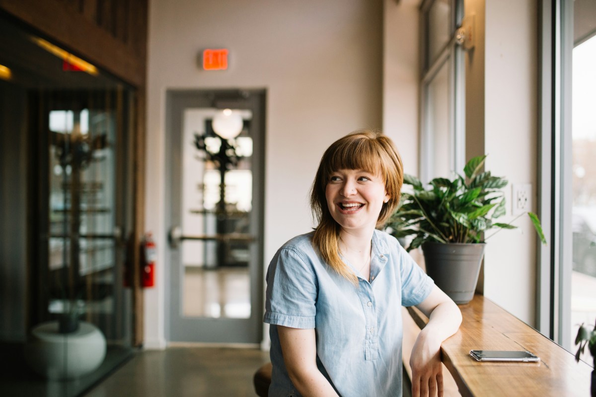 Smiling woman sitting by a window