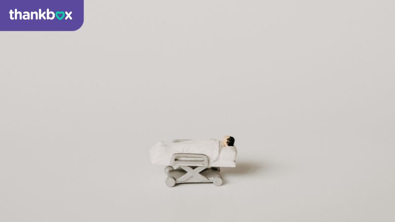 A miniature hospital trolley and patient for a funny get well soon message