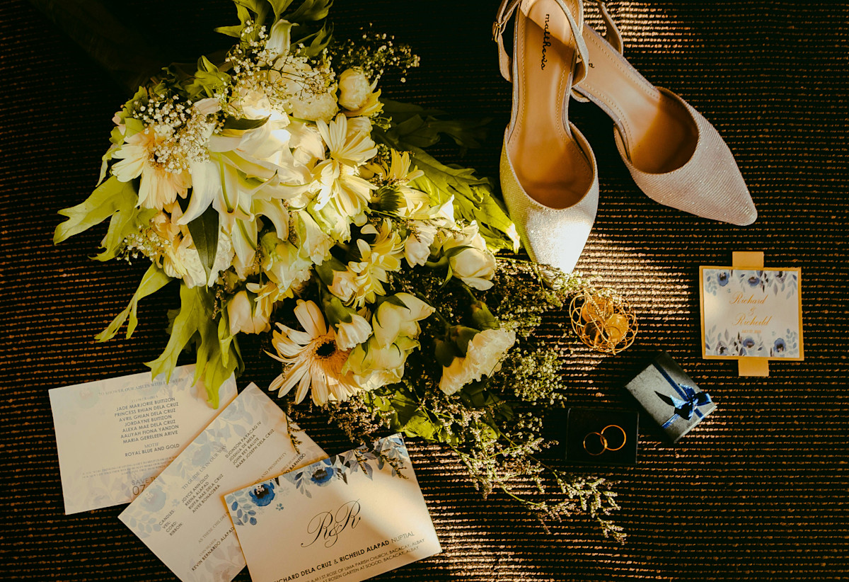 Pair Of Beige Shoes Beside Bouquet and Cards