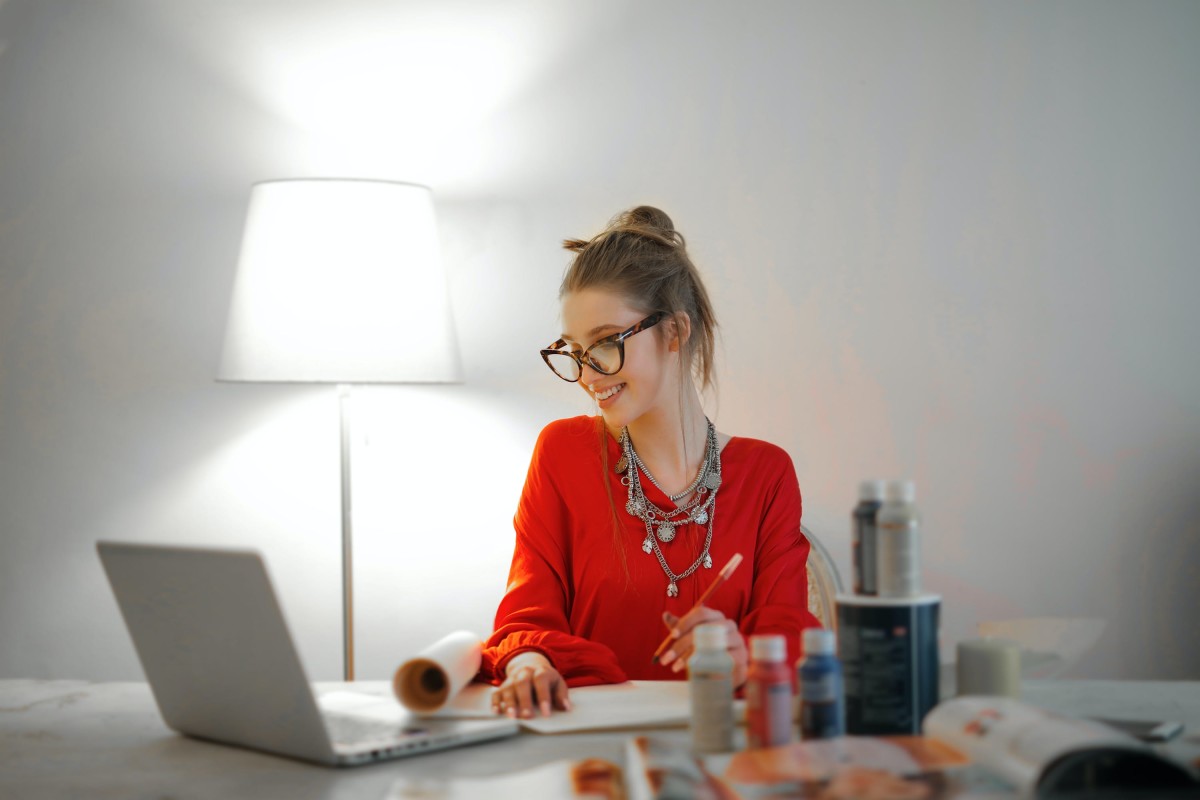 Woman in red long-sleeve shirt working from home