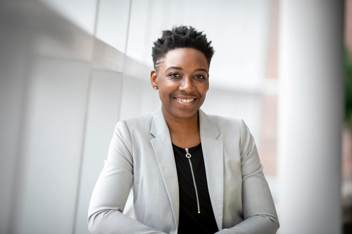 Smiling woman wearing gray suit