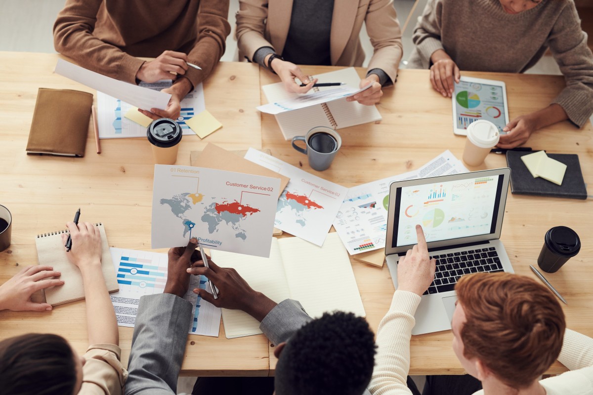 Group of people seated around a table working on a project