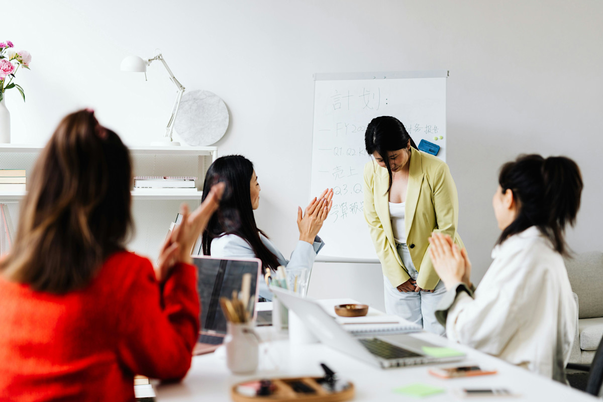 A Woman being Praised after a Presentation
