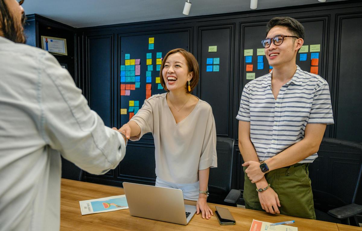 Woman shaking hands with man