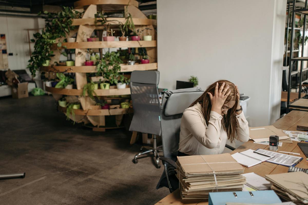 Stressed woman working alone in the office