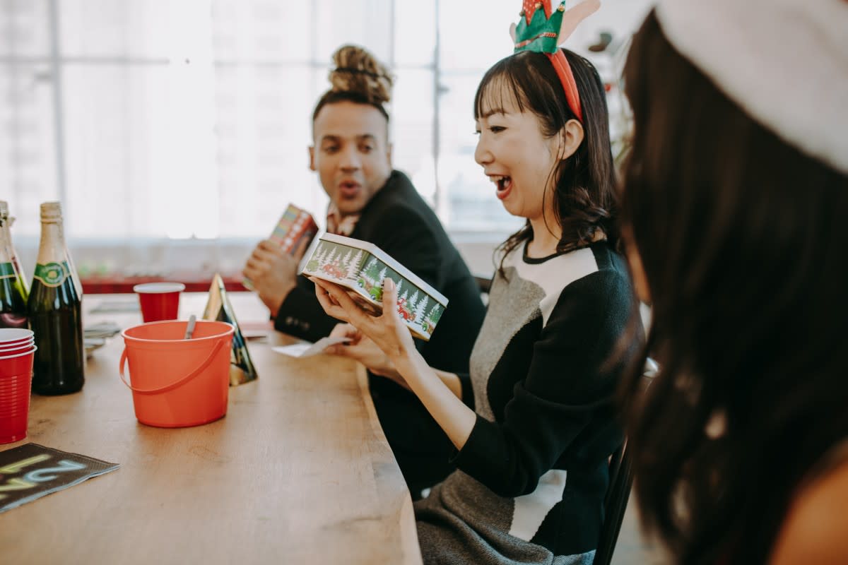 Excited Asian woman opening a present