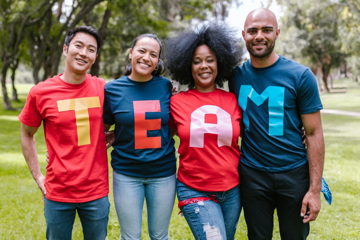Group of people wearing T-shirts that spell Team