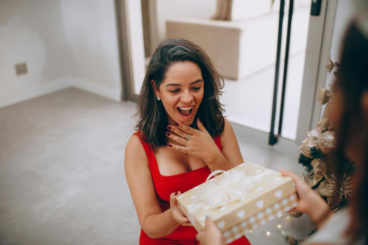 Surprised woman receiving a gift